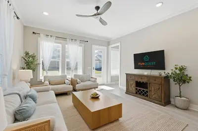 a living room with a couch and a tv at Family Coastal Escape in Inlet Beach