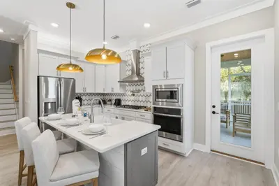 a kitchen with white cabinets and a white counter top at Family Coastal Escape in Inlet Beach