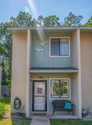a house with two birds on the side of it at Sea This Way in Panama City Beach