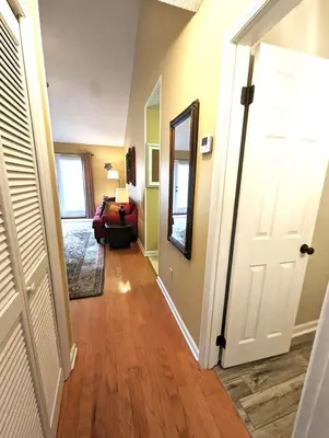 a hallway with a door leading to a living room at The Shell House in Panama City Beach