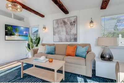 a living room with a couch and a table at The Cozy Jamozy in Panama City Beach