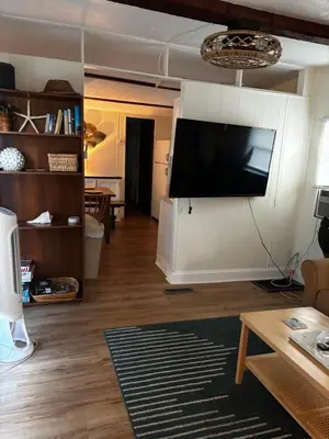 a living room with a flat screen tv on a wall at The Cozy Jamozy in Panama City Beach