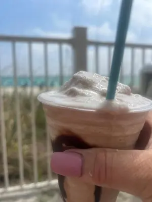a hand holding a drink with a straw in it at Cheap Getaway, Ocean View, PCB in Panama City Beach