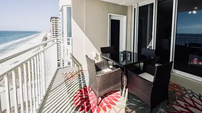 a balcony with a table and chairs and the ocean at Cheap Getaway, Ocean View, PCB in Panama City Beach