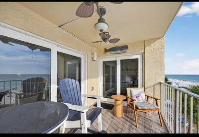 a balcony with a table and chairs and the ocean at Our Sea Side in Panama City Beach