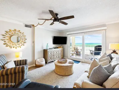 a living room with a couch and a television at Our Sea Side in Panama City Beach