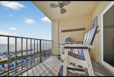 a balcony with two chairs and a view of the beach at Our Sea Side in Panama City Beach