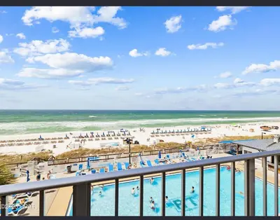 a view of the beach from a balcony at a resort at Our Sea Side in Panama City Beach