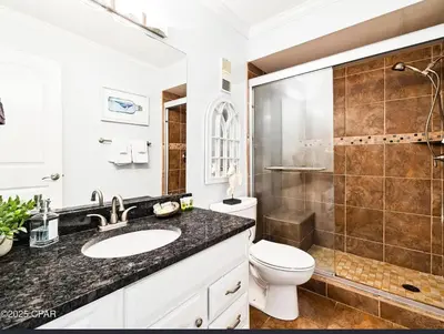 a bathroom with a sink and a toilet and a shower at Our Sea Side in Panama City Beach