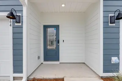 a blue door on a house with a white house at Bright 3BR Near Beach Vacation House in Panama City Beach