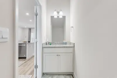 a bathroom with a sink and a mirror at Bright 3BR Near Beach Vacation House in Panama City Beach