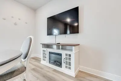 a living room with a fireplace and a tv on the wall at Bright 3BR Near Beach Vacation House in Panama City Beach