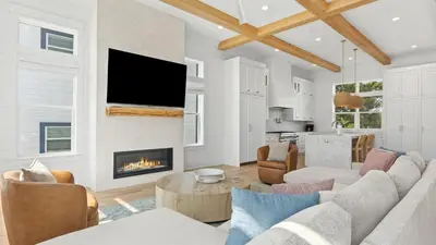a living room with a couch and a fireplace at Spacious Coastal Retreat Near Inlet Beach with Bikes Balconies Modern Design Bluewater View by Avantstay in Inlet Beach