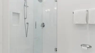 a bathroom with a shower with a glass door at Spacious Coastal Retreat Near Inlet Beach with Bikes Balconies Modern Design Bluewater View by Avantstay in Inlet Beach