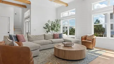 a living room with a couch and chairs and a table at Spacious Coastal Retreat Near Inlet Beach with Bikes Balconies Modern Design Bluewater View by Avantstay in Inlet Beach