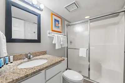 a bathroom with a toilet and a sink and a shower at Commodore 0806 in Panama City Beach