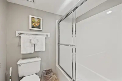 a bathroom with a shower and a toilet at Commodore 0806 in Panama City Beach