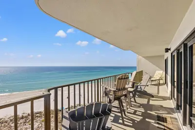 a balcony with chairs and a view of the ocean at Commodore 0806 in Panama City Beach