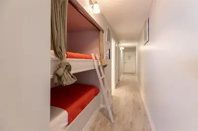 a hallway with two bunk beds in a room at The Summit 618 - Bright Waterfront Condo in Panama City Beach