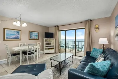 a living room with a couch and a table at The Summit 1023 - Gulf Front Condo in Panama City Beach