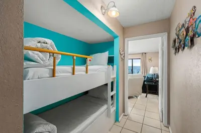 a bedroom with blue walls and a bunk bed at The Summit 1023 - Gulf Front Condo in Panama City Beach