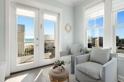 a living room with two chairs and a balcony at Gulf & Lake Views, 6 BR, Pool & 2 minute walk to the beach! in Santa Rosa Beach
