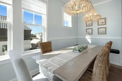 a dining room with a table and chairs and a chandelier at Gulf & Lake Views, 6 BR, Pool & 2 minute walk to the beach! in Santa Rosa Beach