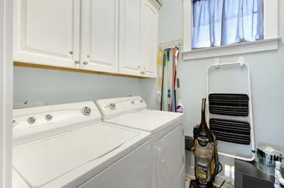 a white laundry room with a washer and dryer at Gulf & Lake Views, 6 BR, Pool & 2 minute walk to the beach! in Santa Rosa Beach
