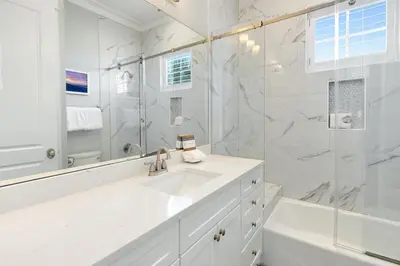a white bathroom with a sink and a shower at Gulf & Lake Views, 6 BR, Pool & 2 minute walk to the beach! in Santa Rosa Beach