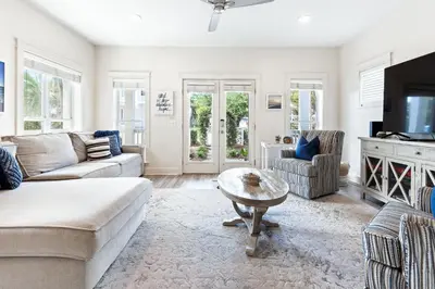 a living room with a couch and a table at Our Seaside 4 BR Seagrove, HEATED Pool, bikes and 5 min to the beach in Santa Rosa Beach