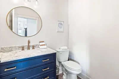 a bathroom with a blue sink and a mirror at Our Seaside 4 BR Seagrove, HEATED Pool, bikes and 5 min to the beach in Santa Rosa Beach