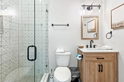 a bathroom with a shower and a toilet and a sink at Our Seaside 4 BR Seagrove, HEATED Pool, bikes and 5 min to the beach in Santa Rosa Beach