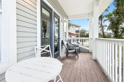 a white porch with a white table and chairs at Our Seaside 4 BR Seagrove, HEATED Pool, bikes and 5 min to the beach in Santa Rosa Beach