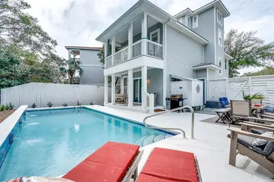 a swimming pool in front of a house at Our Seaside 4 BR Seagrove, HEATED Pool, bikes and 5 min to the beach in Santa Rosa Beach