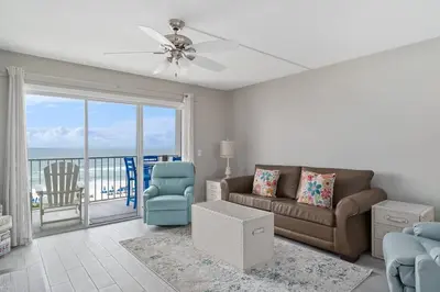 a living room with a couch and a chair at The Summit 529 - Newly Remolded Beachfront Condo in Panama City Beach