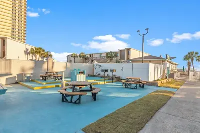 a picnic area with picnic tables on a sidewalk at The Summit 524 in Panama City Beach