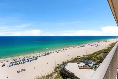 a view of the beach from the balcony of a resort at The Summit 1502 - Family Getaway & Beach Chairs in Panama City Beach