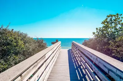 a wooden boardwalk leading to the ocean on a beach at Beachwood Villas 1G - The Nest at Seagrove in Santa Rosa Beach