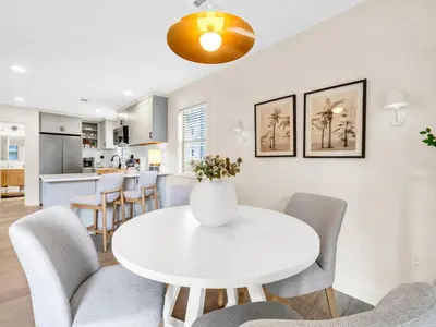 a white dining room with a white table and chairs at Beachwood Villas 1G - The Nest at Seagrove in Santa Rosa Beach