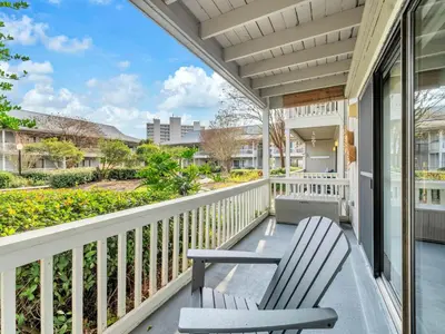 a porch with two chairs on a balcony at Beachwood Villas 1G - The Nest at Seagrove in Santa Rosa Beach