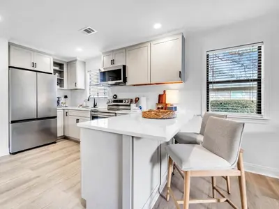a kitchen with white cabinets and a white counter top at Beachwood Villas 1G - The Nest at Seagrove in Santa Rosa Beach