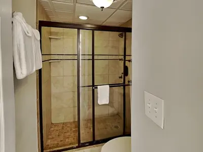 a shower with a glass door in a bathroom at Edgewater Tower I #1203 in Panama City Beach