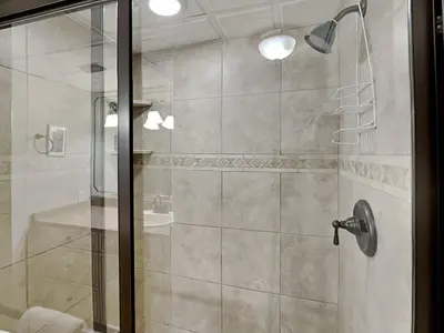 a bathroom with a shower with a glass door at Edgewater Tower I #1203 in Panama City Beach