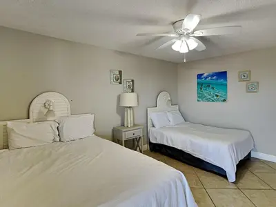 a bedroom with two beds and a ceiling fan at Edgewater Tower I #1203 in Panama City Beach