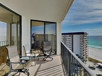 a balcony with chairs and a view of the ocean at Edgewater Tower I #1203 in Panama City Beach