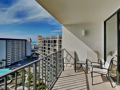 a balcony with chairs and a table and a view at Edgewater Tower I #1203 in Panama City Beach