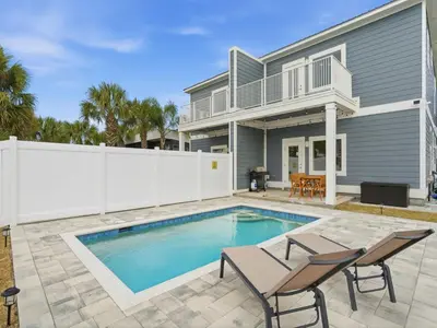 a swimming pool in front of a house at Horizon Dreams A in Panama City Beach