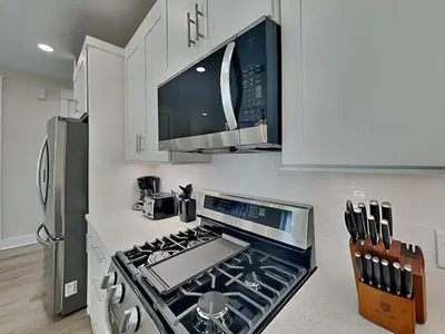 a kitchen with a stove top oven next to a refrigerator at Horizon Dreams A in Panama City Beach