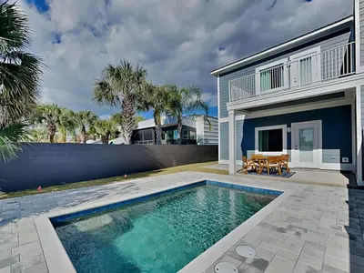 a swimming pool in front of a house at Horizon Dreams B in Panama City Beach