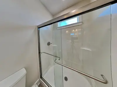 a shower with a glass door in a bathroom at Horizon Dreams in Panama City Beach